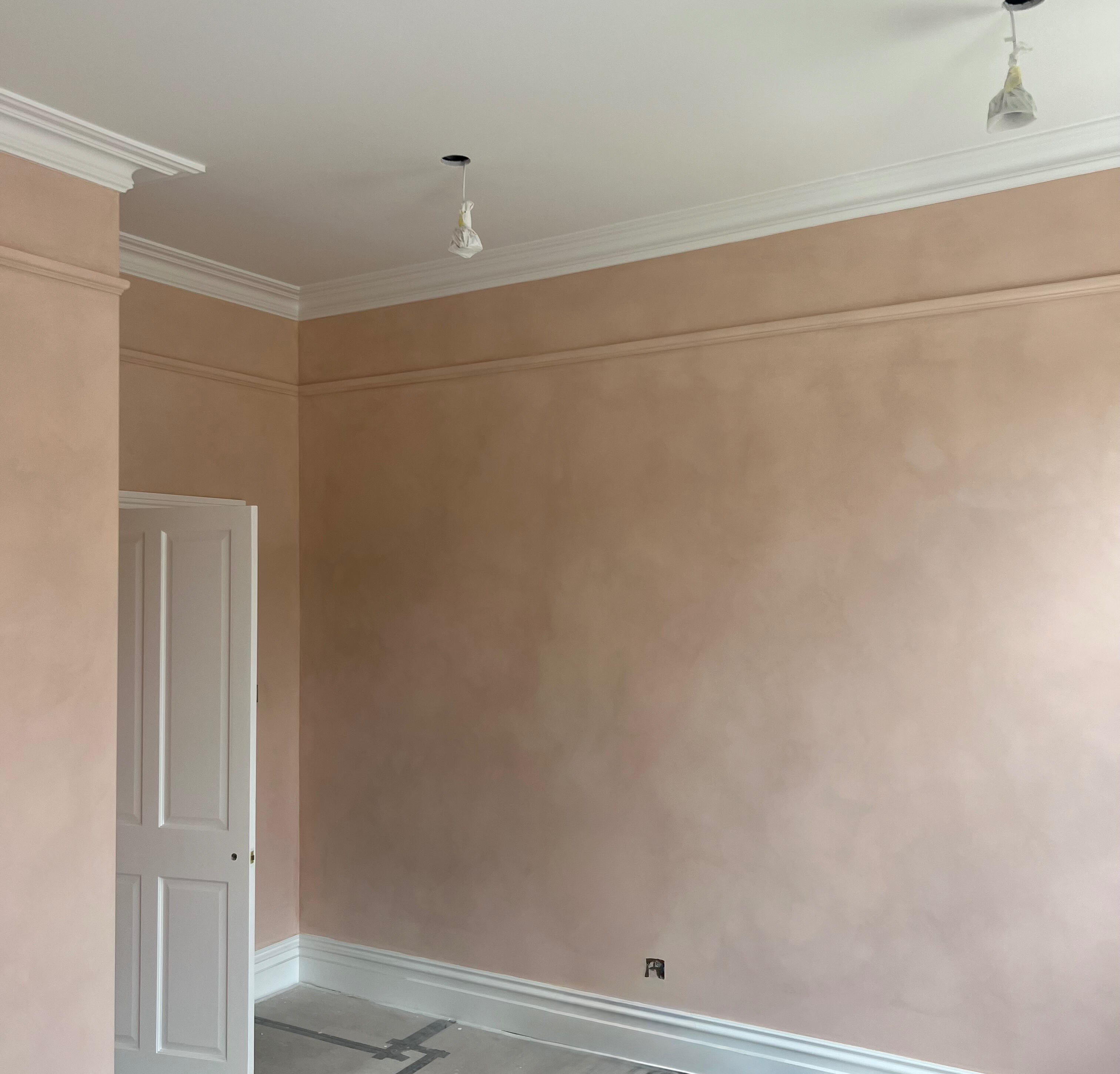 Terracotta painted walls and white cornice in a period London property mid renovation